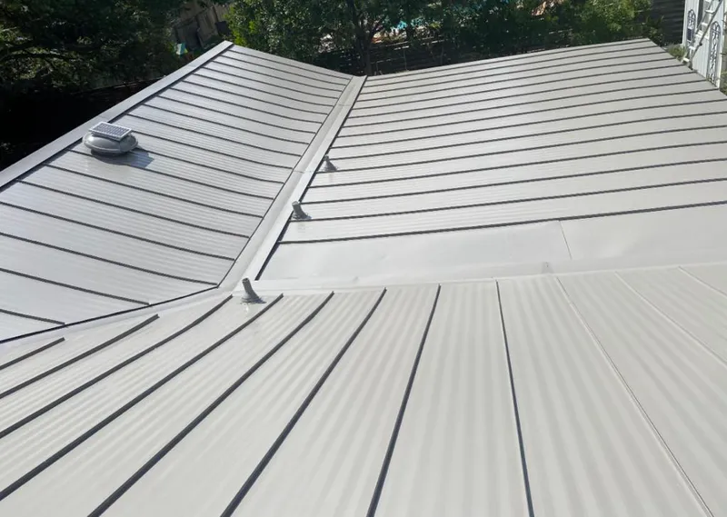 Solar attic fan installed on a metal roof for Roof Ventilation in Lamar